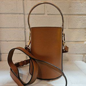 Chic Cylindrical Leather Handbag with Elegant Gold-Tone Hardware